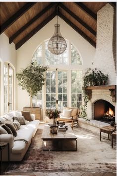 a living room filled with furniture and a fire place in front of a large window