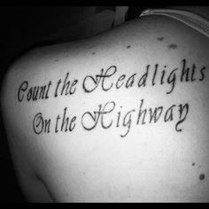 the back of a man's shoulder with an inscription that reads, count the deadlights on the highway