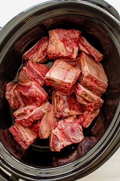 raw meat is in the slow cooker ready to be put into the crock pot