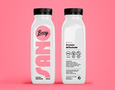 two bottles of milk on a pink background