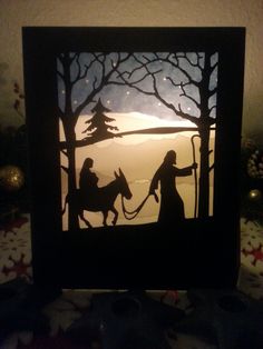 a paper cut nativity scene depicting the birth of jesus