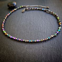 This dainty rainbow hematite star choker/necklace is handmade using a multitude of tiny 4 millimetre rainbow hematite star beads that twinkle beautifully as they catch the light. The round beads and metal findings are all stainless steel  The necklace comes in various lengths and has an additional 2 inch extender chain. This means that the wearer can chose the perfect fit and placement of the piece.  As well as being a beautiful stone, hematite is said to protect the wearer's vita energy and guarantee survival. Disclaimer - we do not guarantee that this choker will protect your vita energy or make you immortal 😉 Please visit my shop if you'd like to see my full selection of jewellery and other items 😊https://www.etsy.com/uk/shop/SausageMouseStudio Celestial Boho, Choker Necklace Handmade, Rainbow Hematite, Star Choker, Hematite Jewelry, Star Beads, Boho Jewellery, Handmade Uk, Rainbow Necklace