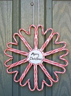 candy canes arranged in the shape of a star with a merry christmas sign on it