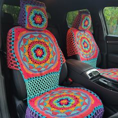 the interior of a car with colorful crocheted blankets