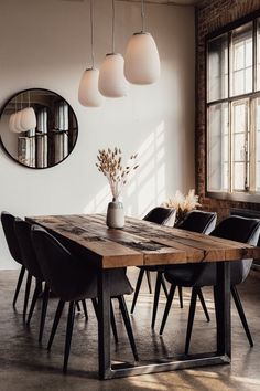 a wooden table with black chairs and a plant in a vase on top of it