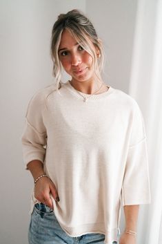 Elevate your casual wardrobe with the Evening Stroll Sweater Top, a versatile and chic piece that transitions effortlessly from day to night. This top is crafted in a soft cream knit that exudes subtle elegance. Its crew neckline is complemented by wide ribbed detailing, while the dropped shoulder seams and slouchy sleeves add to its laid-back vibe. The cozy knit texture gives it a timeless, casual charm, making it perfect for layering or wearing solo on cool evenings. Fabric: 100% Cotton Produc Beige Crew Neck Soft Knit Sweater, Beige Soft Knit Crew Neck Sweater, Relaxed Cream Tops For Fall, Beige Knit Top For Loungewear, Chic Relaxed Fit Knit Top For Everyday, Cream Soft Knit Tops For Layering, Cozy Beige Knit Top For Spring, Oversized Knit Top, Chic Textured Knit Crew Neck Sweater