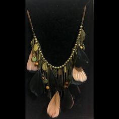 Bohemian Vibes Black And Tannish Beige Feathers Dark Gold Color Chain Tassels Beads Brown Faux Suede Cord Statement Necklace Lobster Clasp Approximately 24 Inches, 2 Inch Extension From Smoke-Free And Pet-Free Home Bohemian Fringe Necklace, Bohemian Fringe Tassel Necklace For Parties, Brown Tassel Jewelry For Festivals, Adjustable Bohemian Necklaces With Feathers, Brown Tassel Necklace For Festival, Adjustable Dangle Tassel Necklace For Festivals, Bohemian Party Jewelry With Feathers, Bohemian Tassel Necklace With Dangling Beads, Bohemian Brown Jewelry With Beaded Fringe