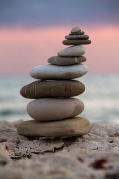 a stack of rocks sitting on top of a sandy beach