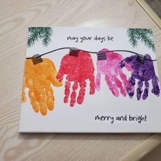 a card with handprints on it that says merry and bright hanging from a string