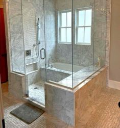 a bathroom with a walk in shower next to a bath tub