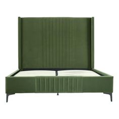 an upholstered bed with green velvet headboard and foot board, viewed from the side