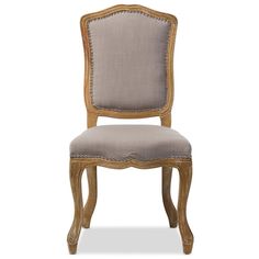 an upholstered chair with beige fabric and gold trimmings on the back