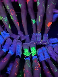 glow in the dark shoes are arranged on top of each other, with neon colors