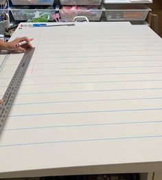 two people are working on a large piece of paper