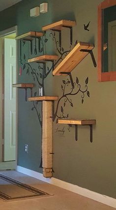 a cat tree is in the middle of a room with several shelves on each side