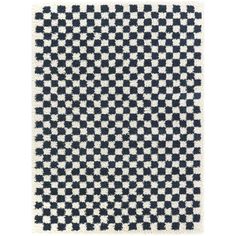 a black and white checkered rug on a white background with an area rug in the middle