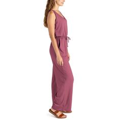 Made from super soft, lightweight stretchy fabric, this jumpsuit is designed to be worn for any season or occasion, making it a staple in your wardrobe. The flattering relaxed fit and wide-leg style with side pockets add a touch of casual sophistication, while the open V-neck and elastic waistband with a drawstring tie create a flattering silhouette that complements any body type. Dress it down with your favorite sandals for a laid-back daytime look or dress it up with wedges and sparkling state Casual Wide Leg Jumpsuits And Rompers For Loungewear, Casual Wide-leg Jumpsuit For Loungewear, Solid Maxi Length Jumpsuits And Rompers For Loungewear, Maxi Length Jumpsuits And Rompers For Loungewear, Casual Relaxed Fit Maxi Dress, Comfortable Beach Jumpsuits And Rompers For Summer, Relaxed Fit Maxi Length Jumpsuits And Rompers, Comfortable Summer Beach Jumpsuits And Rompers, Casual Jumpsuits And Rompers With Tie Waist