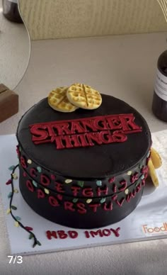 there is a cake that says strange things on the side and waffles in the middle