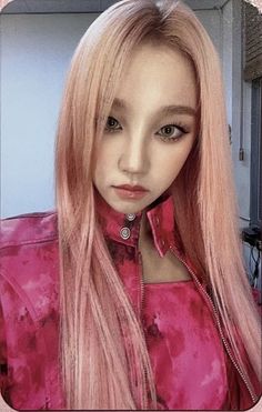 a woman with long pink hair wearing a collared shirt and piercings on her neck