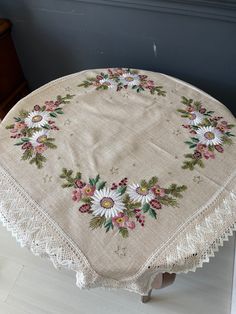 a table cloth with daisies on it