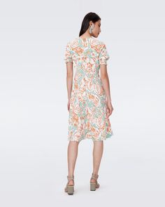 Cut from a vintage crepe, the Jemma dress falls in a romantic, airy drape. This piece has a V-neckline, puffed half-sleeves with comfortable smocking, and an A-line fit. With a hidden back zip, it's an effortless in-and-out piece for warmer weather. Yu-en is 5 Foot and 7 Inches and wearing a size 2. Flowy Dress With Pleated Short Sleeves, Flowy Short Sleeve Dress With Pleated Sleeves, Daywear Smocked Dress With Gathered Sleeves, Summer Flowy Puff Sleeve Dress With Gathered Neckline, Short Sleeve Ruched Smocked Dress For Garden Party, V-neck Midi Dress With Gathered Neckline For Brunch, Ruched Short Sleeve Smocked Dress For Garden Party, Daywear Ruched Viscose Dress, Viscose Ruched Dress For Daywear