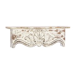 an old white wooden shelf with ornate carvings on the front and back end, against a white background