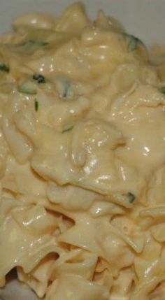 closeup of macaroni and cheese in a white bowl on a wooden table