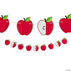 an apple banner with apples hanging from it