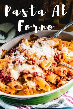 pasta al forto with cheese and sauce in a green bowl on top of a checkered table cloth