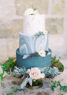 a three tiered blue and white wedding cake