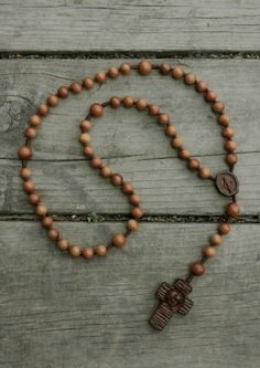 +.The cross is three-dimensionally carved and incredibly detailed. Because of the design and color of the wood, a cross with a unique feel was produced. Meditation Rosary With Wooden Beads And Cross Shape, Brown Cross-shaped Rosary With Wooden Beads, Brown Wooden Beaded Cross Rosary, Wooden Beads Rosary With Crucifix As Gift, Brown Rosary With 8mm Beads And Cross Shape, Gift Rosary With Wooden Beads And Crucifix, Brown Rosary With 8mm Beads, Wooden Rosary, Light Brown Color