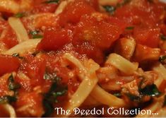 pasta with tomato sauce and spinach in a white bowl