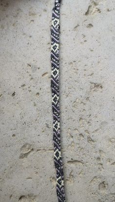 a close up of a bracelet on the ground