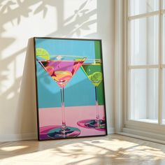 a painting of two martini glasses with limes on the rim