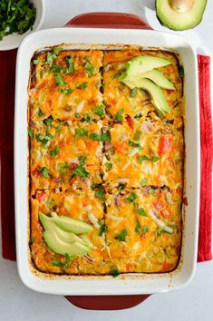 an enchilada casserole with avocado, cilantro and cheese