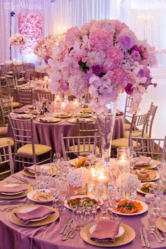 an image of a table set up with flowers and candles for a wedding or special event