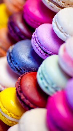 there are many different colored macaroons on display