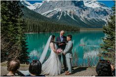 a bride and groom standing in front of a mountain lake with their wedding ceremony vows