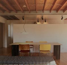 an empty room with several chairs and a table