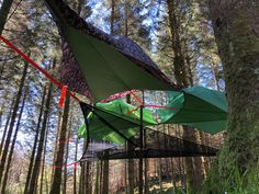 an upside down tent in the middle of a forest