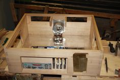 a wooden box filled with tools on top of a table