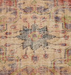 an old rug with many different colors and patterns