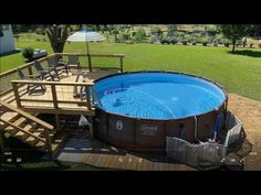 an above ground swimming pool with deck and stairs