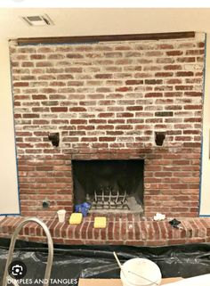 a brick fireplace being installed in a living room