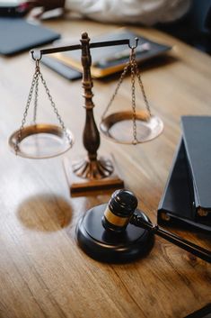 a wooden table topped with a scale and gaven on top of it next to a laptop computer