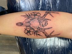 a tattoo on the arm of a woman with flowers