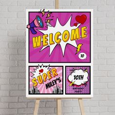 a welcome sign on an easel in front of a brick wall with pop art