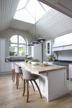 a large kitchen with an island in the middle