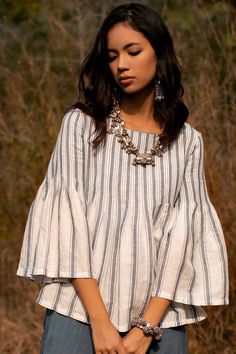 Off white, ecru top with vertical contrast stripes all over. 
Components:1
Neckline:Round
Sleeve Length:Three quarter
Fabric:Cotton Linen
Color:White
Pleated detail 
Flared sleeves 
Note: Pant worn by the model is not for sale - Aza Fashions White Vertical Stripes Blouse For Spring, Elegant White Blouse With Vertical Stripes, Elegant White Tops With Vertical Stripes, Chic White Tops With Striped Sleeves, White Blouse With Vertical Stripes For Summer, White Summer Blouse With Vertical Stripes, Payal Pratap, Fashion App, Top For Women