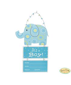 a blue elephant hanging from the side of a sign that says it's a boy